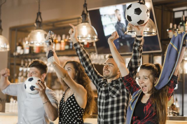 images/group-friends-watching-sport-together-celebrating-victory-bar.jpg