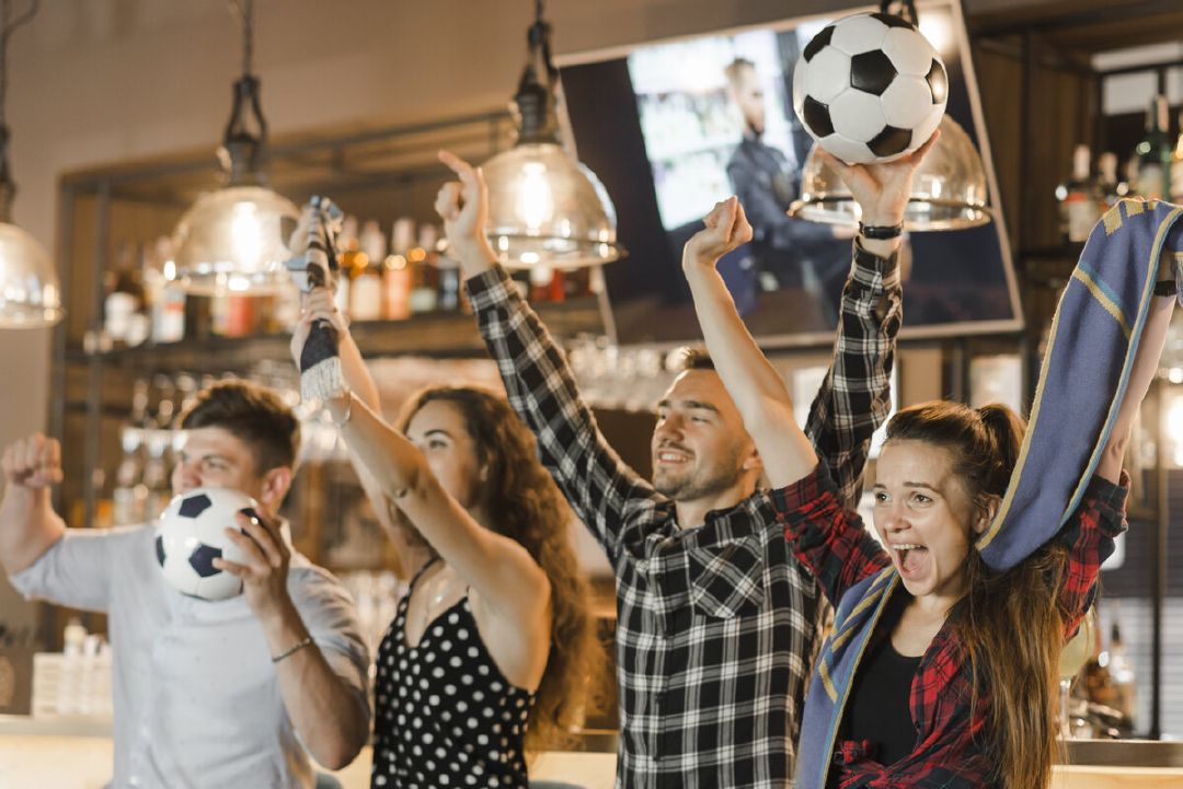 images/group-friends-watching-sport-together-celebrating-victory-bar.jpg